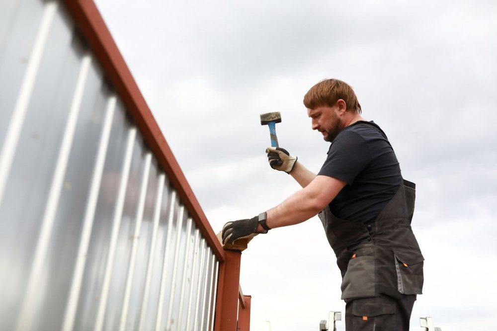 Installer fitting a gate panel into place
