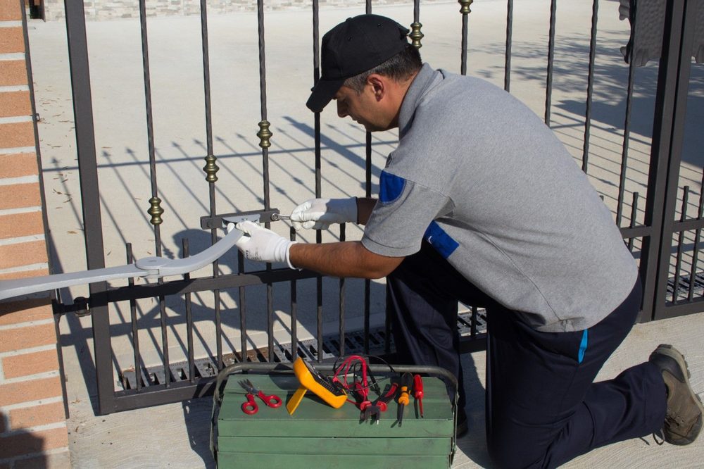 Technician installing gate hardware in Albuquerque