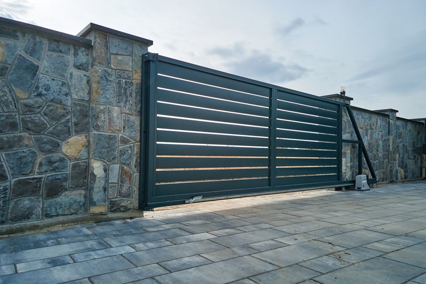 Sliding iron driveway gate on an Albuquerque property