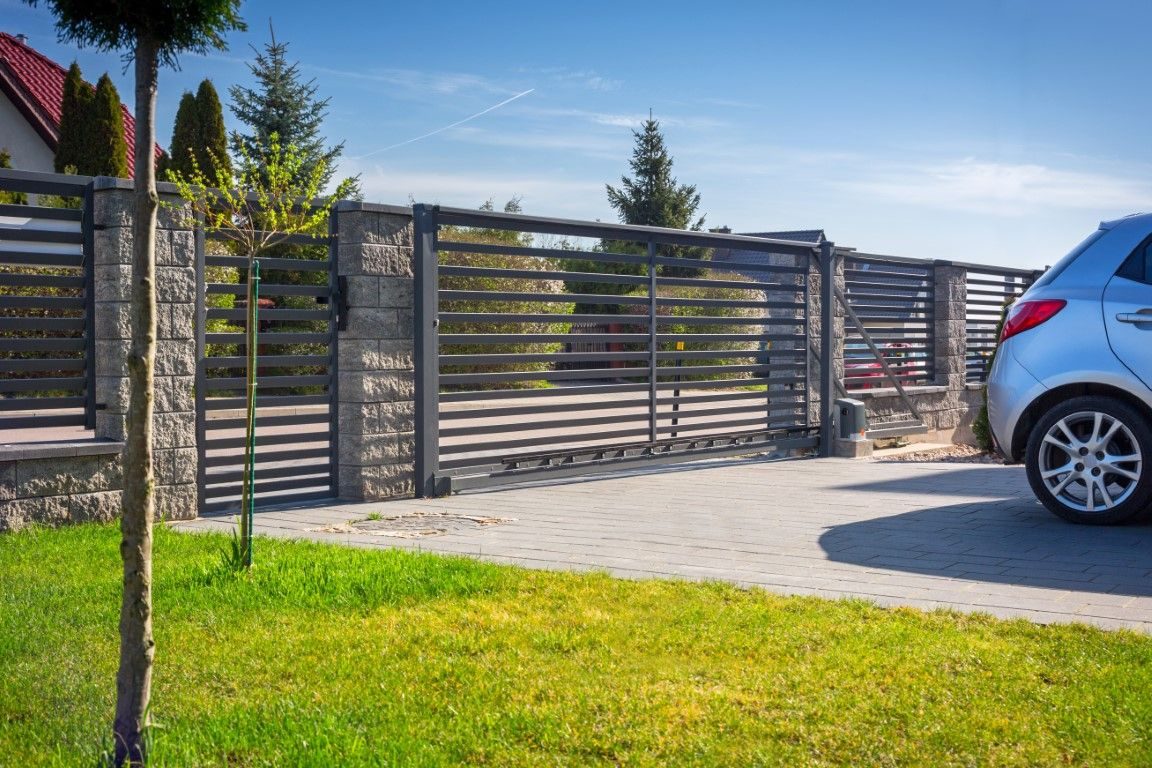 Modern iron driveway gate installed at an Albuquerque home